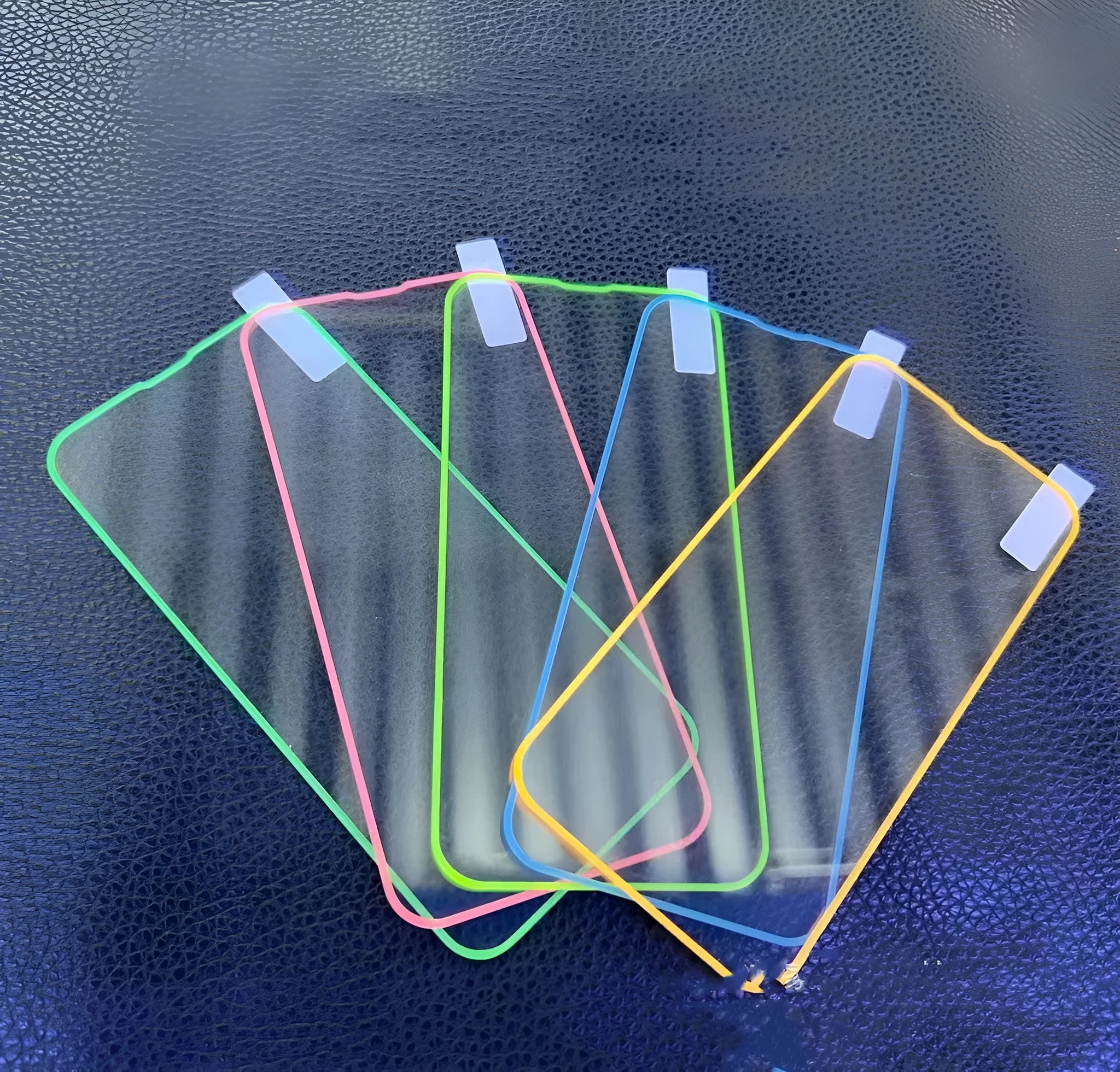 Glow-in-the-dark pink tempered glass screen protector fitted on an iPhone 13 Pro Max showing full-screen coverage.
