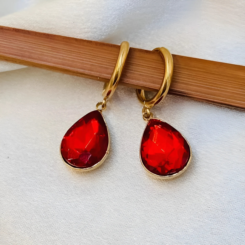 Copper-coloured rare earth metal and glass geometric saturn water drop earrings in multiple colours.