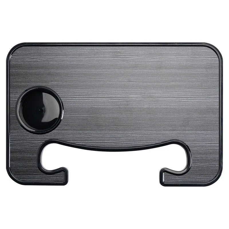 Black foldable car steering wheel laptop stand with a drink cup holder on a table.