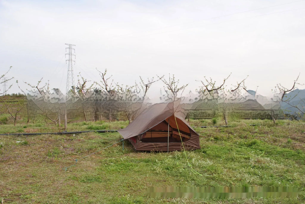 Brown A-line hiking tent pitched using trekking poles with guy ropes secured