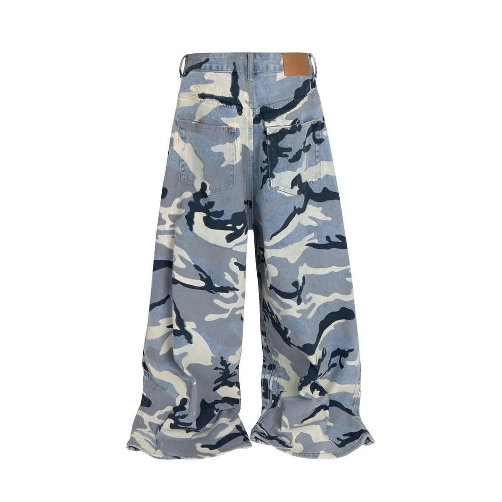 A pair of loose-fit blue jeans with a snow camouflage pattern on a mannequin.