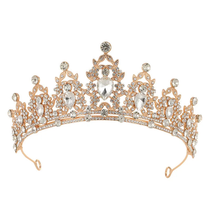 A silver and rhinestone baroque bride crown headdress with intricate detailing on a white background.