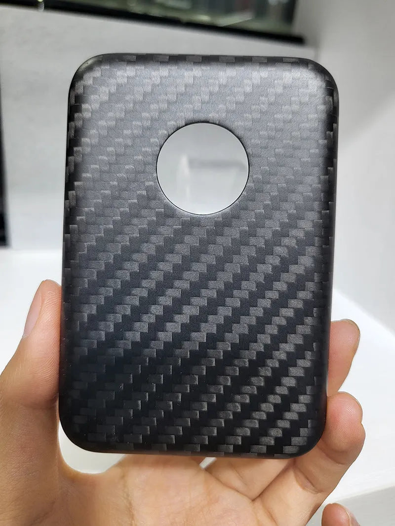 Black Kevlar hard shell case for Apple MagSafe power bank, shown in 3K round hole bright finish.