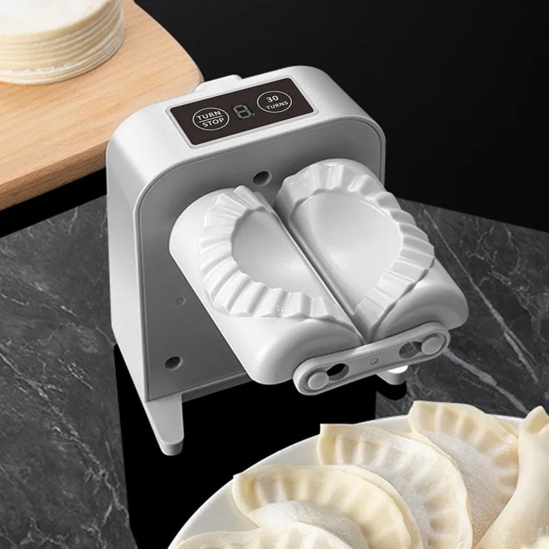 White electric dumpling maker machine with USB cable, brush, and spoon accessories