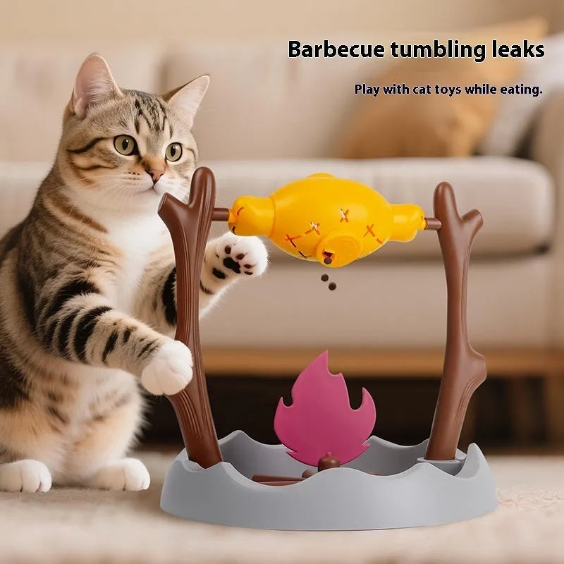 Barbecue-style rolling cat feeder toy with treat compartments, measuring 30cm cubed on a floor.