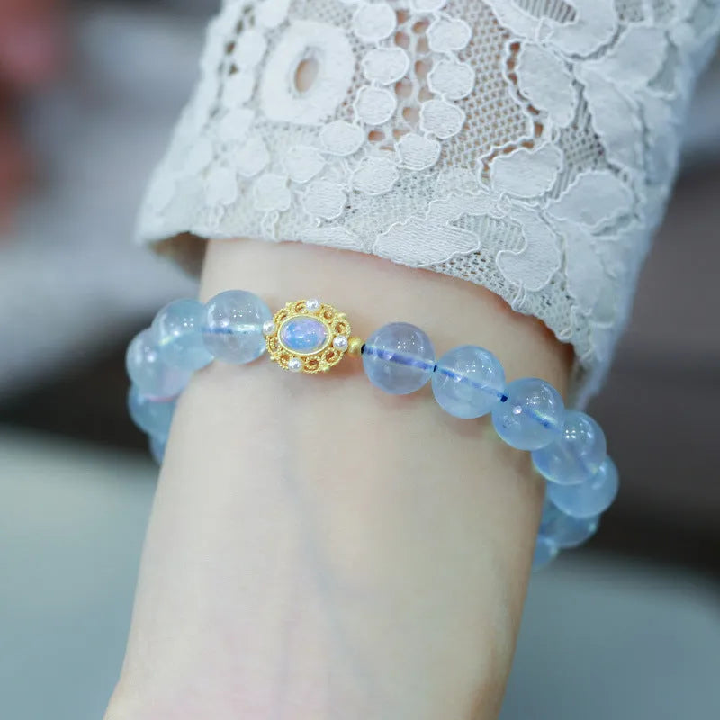 DIY kit components for an aquamarine fox Fengjiu bracelet with pearl and pink crystal beads.
