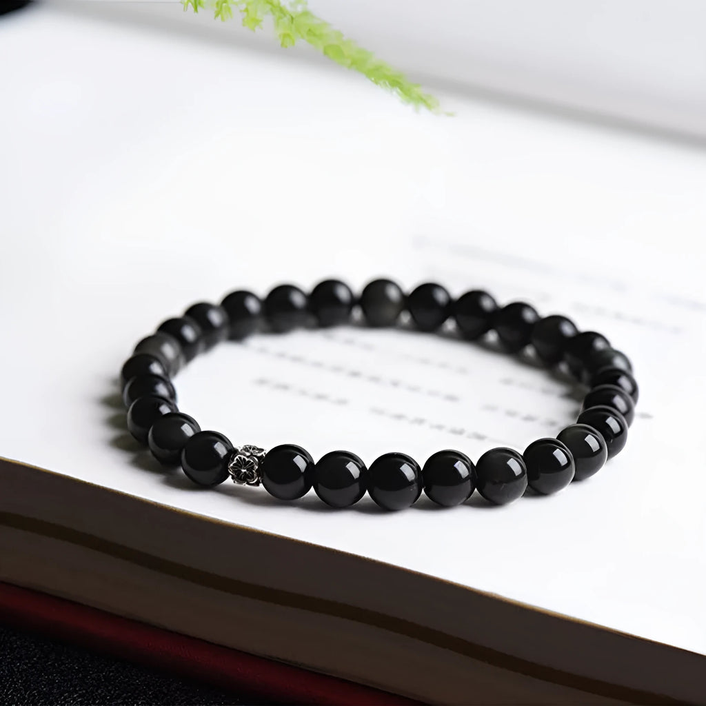 Natural obsidian beaded bracelet with S925 silver flower charms and dragon phoenix constellation design.