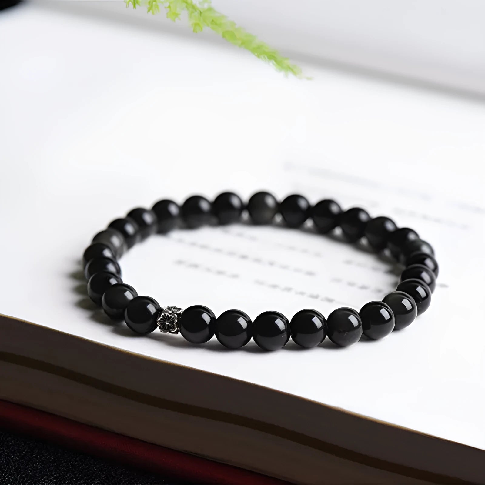 Natural obsidian beaded bracelet with S925 silver flower charms and dragon phoenix constellation design.