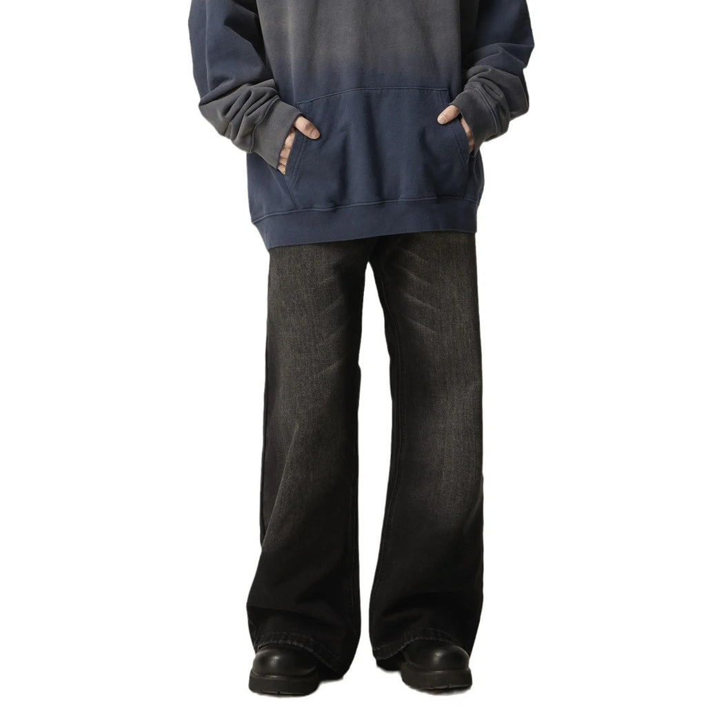 Black loose-fit straight leg denim jeans with a zipper fly on a neutral background.