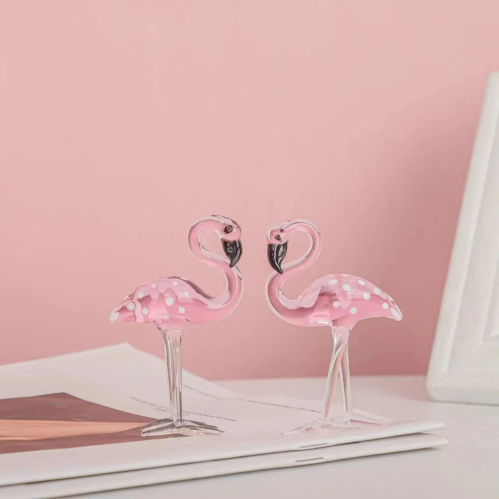 Pink crystal flamingo decorative figure on a table in modern style.