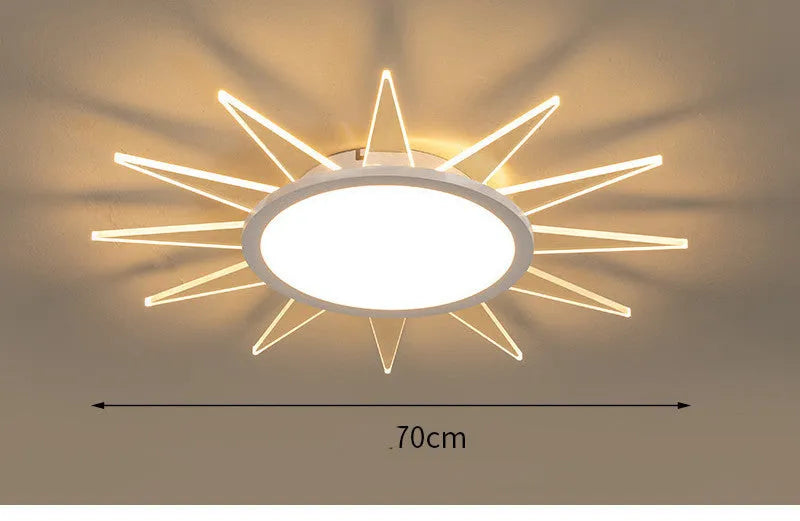 Modern round aluminium LED ceiling lamp with remote control on a white ceiling.