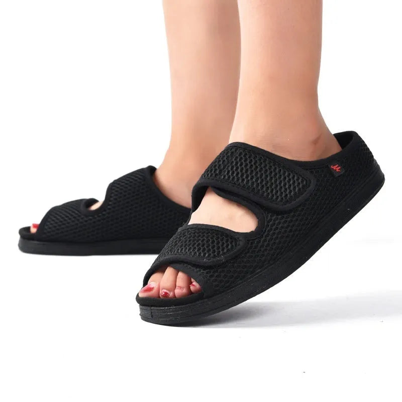 Wide puffy adjustable slippers with mesh upper and rubber sole in black colour
