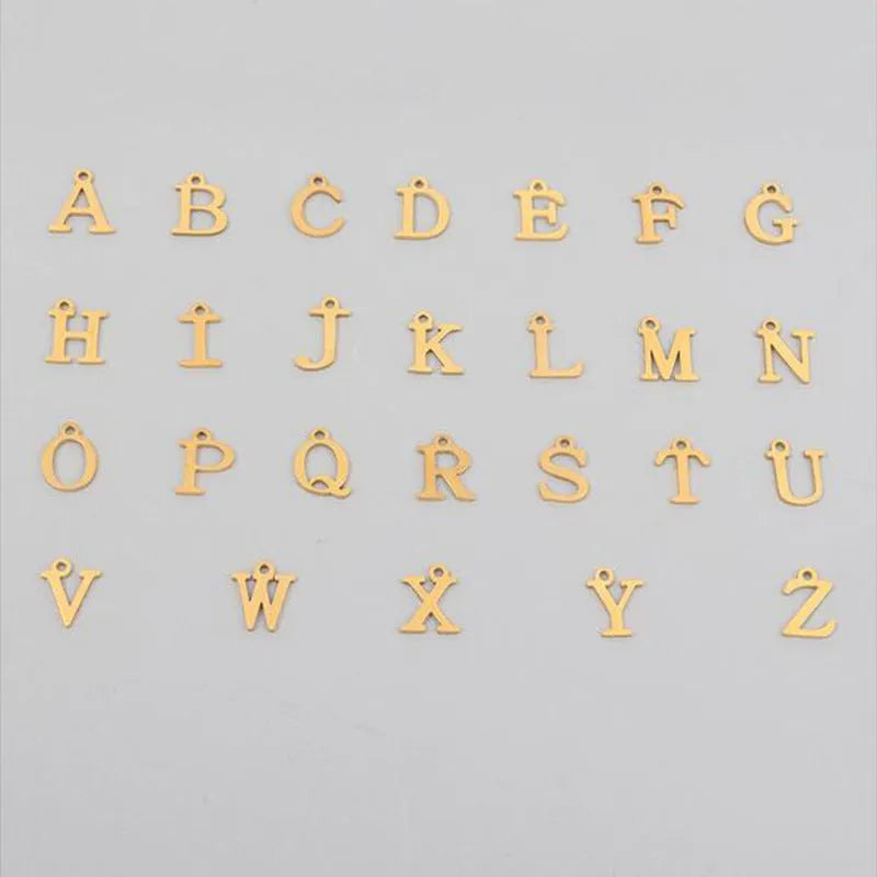 Stainless steel clip chain necklace with raised letter A pendant and imitation pearl in gold colour on a white background