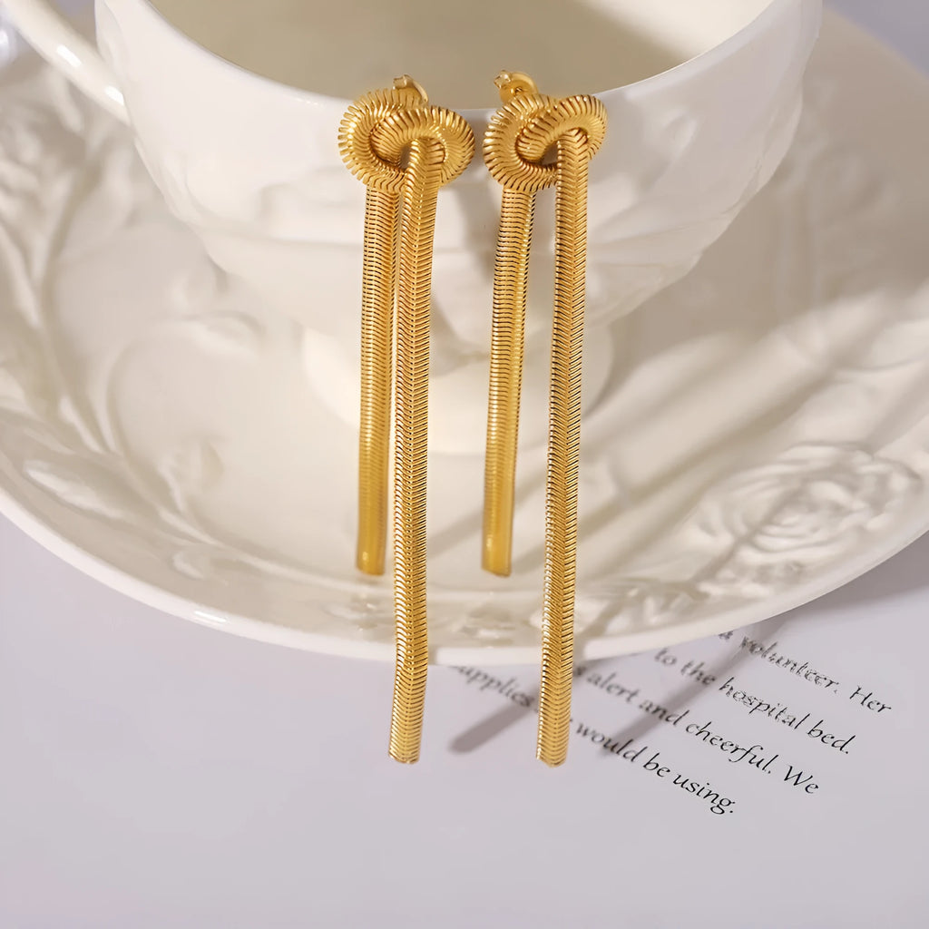 Women's gold knotted tassel necklace on snake chain with matching titanium steel earrings