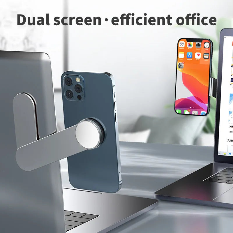 Silver aluminium alloy dual screen extension bracket with magnetic phone mount next to a laptop
