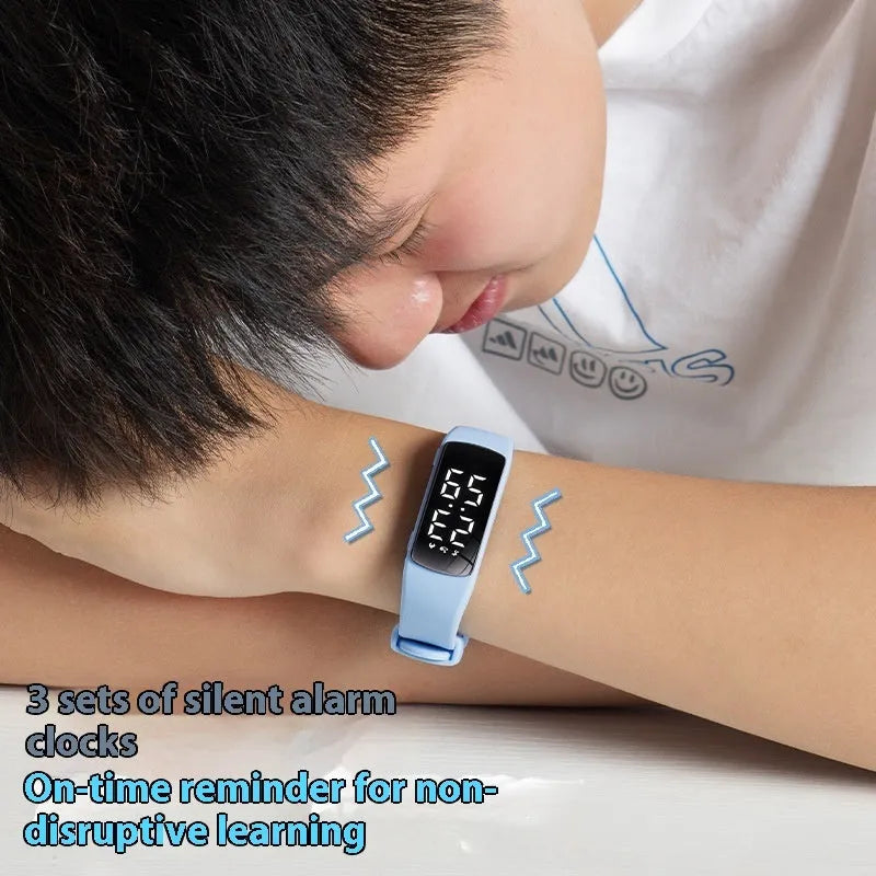 Smart vibration alarm watch with LED display and coloured silicone strap on a wrist