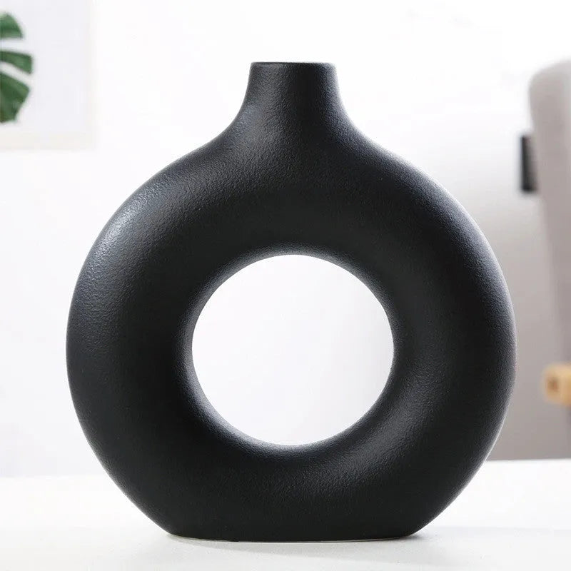 Frosted unglazed porcelain biscuit vase in a simple modern style on a table.