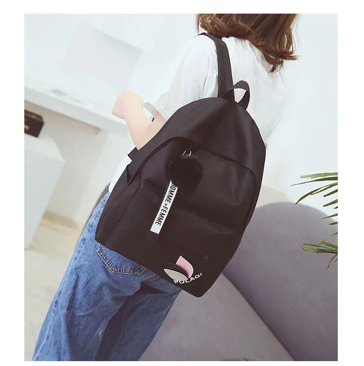 Canvas college backpack with leaf pattern in green colour showing front compartment and straps