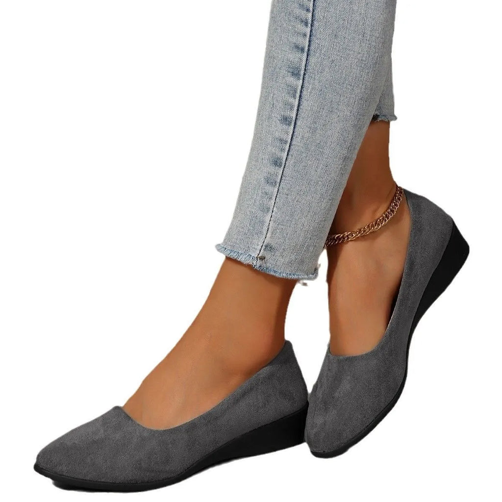 Women's plus size pointed toe wedge pumps in suede with a shallow cut and low rubber heel.