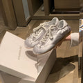 Women's silver grey satin ballet flat shoes with front lace-up design and round toe.