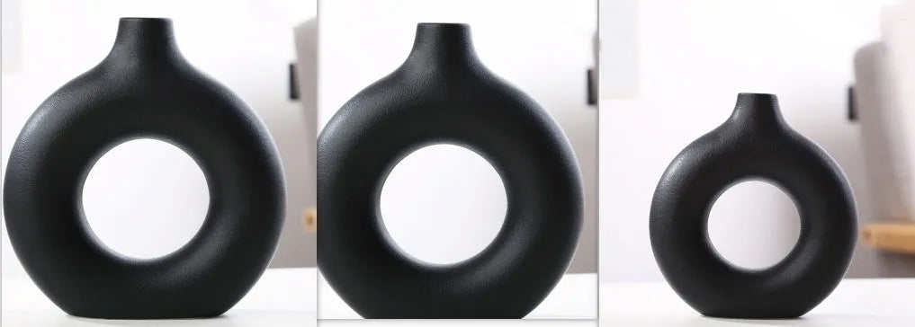 Frosted unglazed porcelain biscuit vase in a simple modern style on a table.