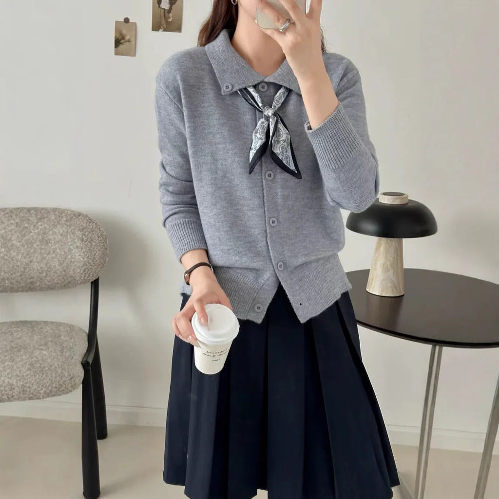 Milky white cardigan sweater with a lapel scarf collar and spliced knit detailing.