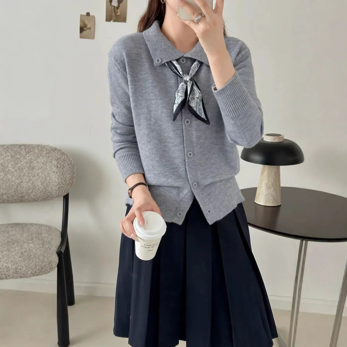 Milky white cardigan sweater with a lapel scarf collar and spliced knit detailing.