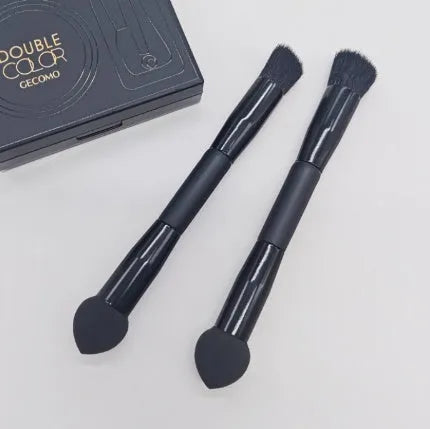 Black double-headed concealer brush with sponge end and tapered brush end on wooden handle