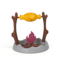 Barbecue-style rolling cat feeder toy with treat compartments, measuring 30cm cubed on a floor.