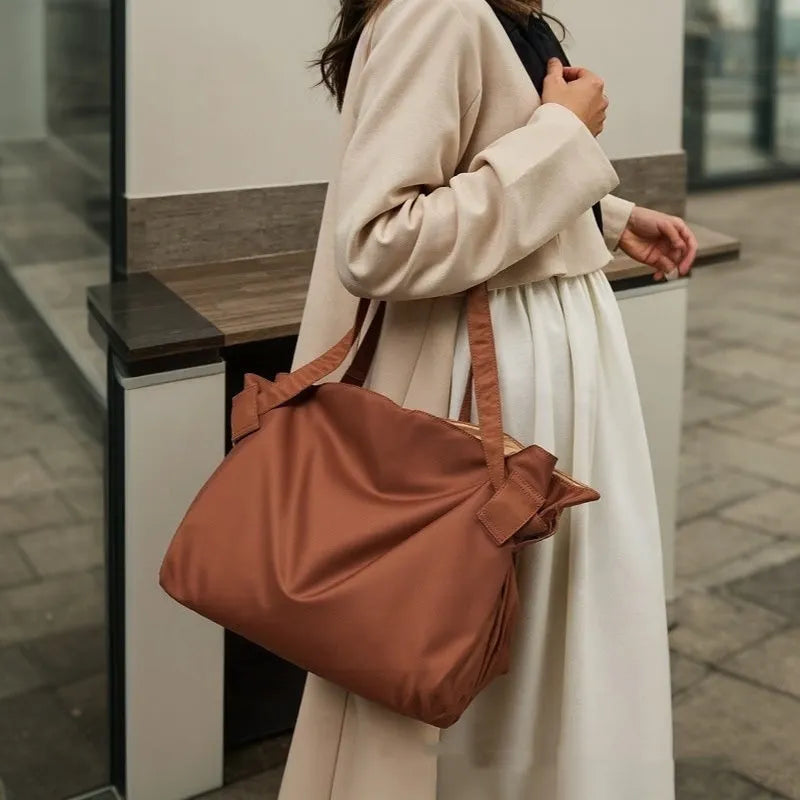 Women's large capacity Oxford cloth crossbody shoulder bag in black or light brown for travel and camping.
