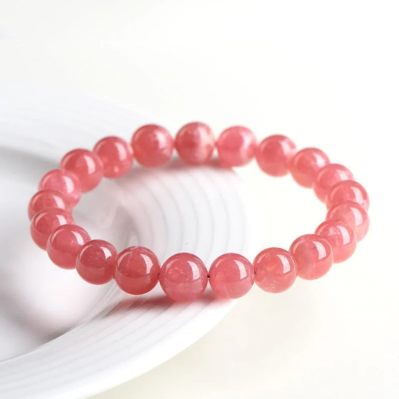 Women's crystal bracelet with a longevity lock clasp and geometric beads in rhodochrosite colours.