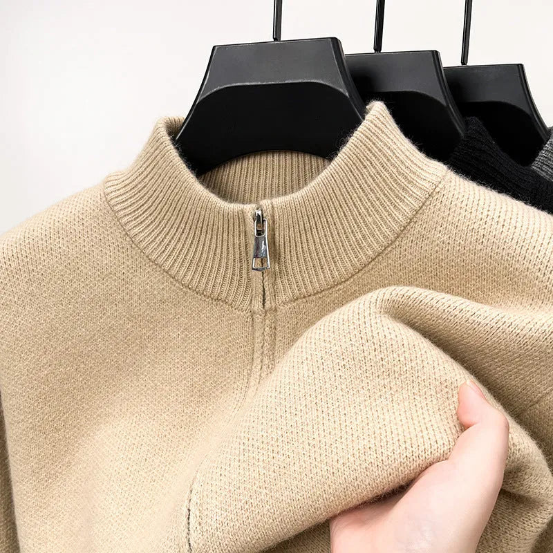 Men's black knitted zip-up cardigan with a stand collar, shown in a loose fit.