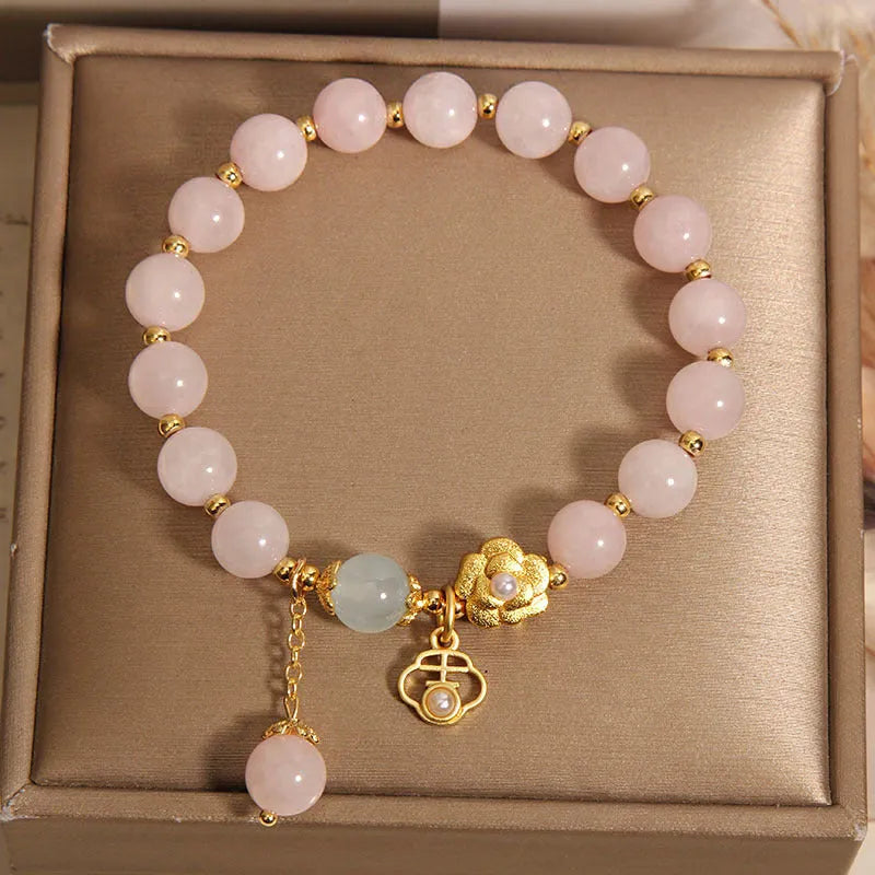 Women's pink crystal bracelet with a refined grace flower design on a wrist.