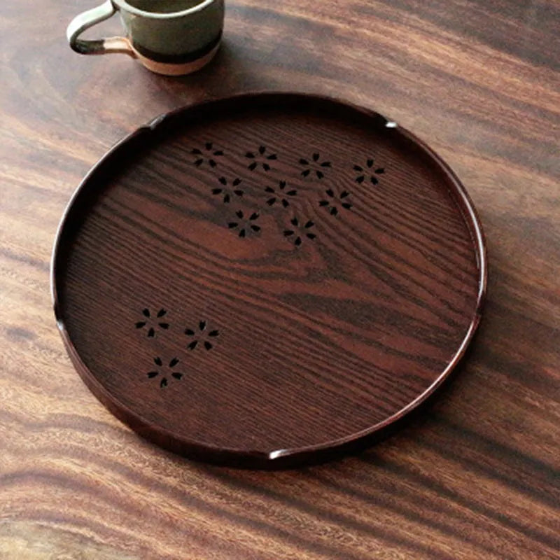 Wooden shallow plate with hollow cherry blossom decoration, 30 cm diameter.