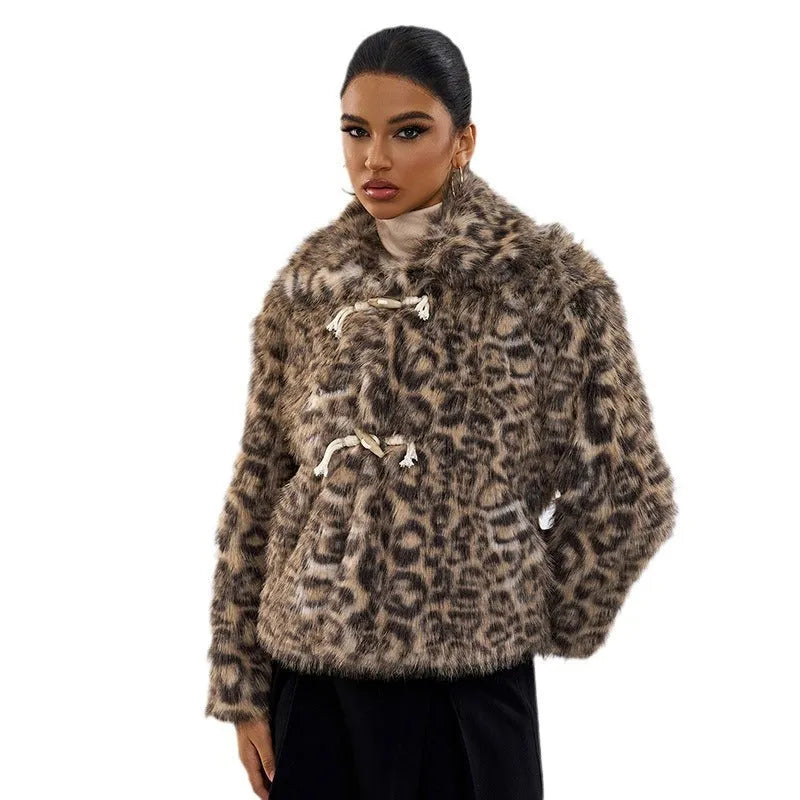 Women's leopard print coat with a buckle lapel closure on a street fashion model.