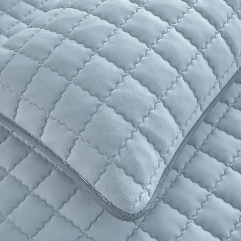 Washed cotton waterproof fitted sheet for beds in blue, shown on a mattress