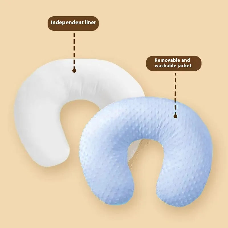 Gray U-shaped nursing pillow with removable cover on a neutral background.