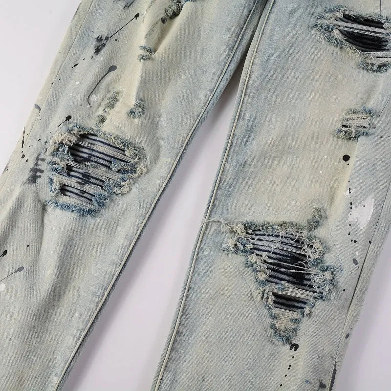 Men's blue light coloured paint splashing ink making old washed denim jeans with small straight leg and zip fly
