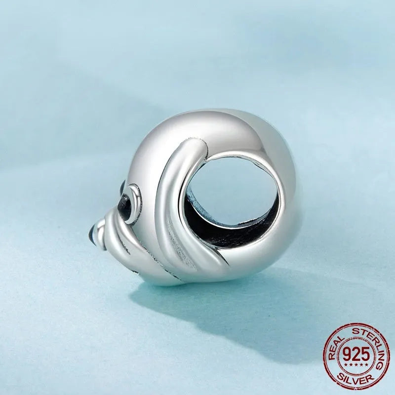 Close up of a single S925 sterling silver bead with golden retriever shape in orange dripping oil finish, 0.8cm high by 1.3cm wide, with 0.45cm aperture
