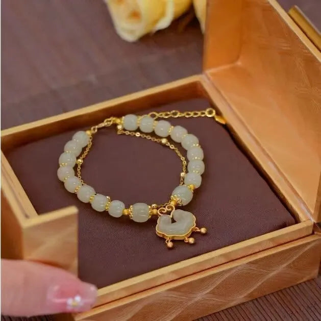 Green women's bracelet with safety lock and bell pendant in drop shape design
