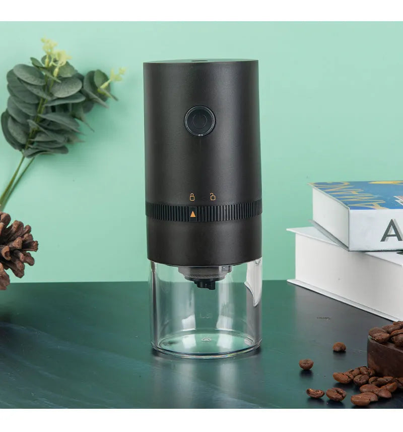 Portable black electric coffee grinder with transparent chamber and USB-C charging cable