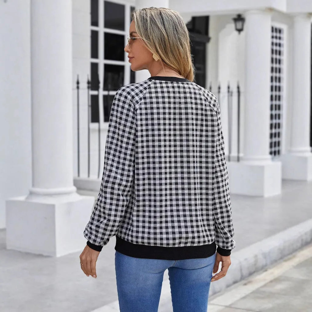 Black polyester pullover sweater with a plaid and printed stripe pattern, long sleeves.