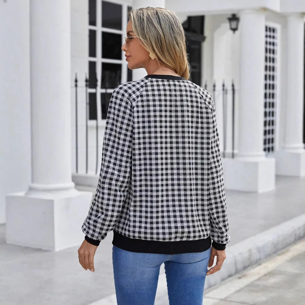 Black polyester pullover sweater with a plaid and printed stripe pattern, long sleeves.