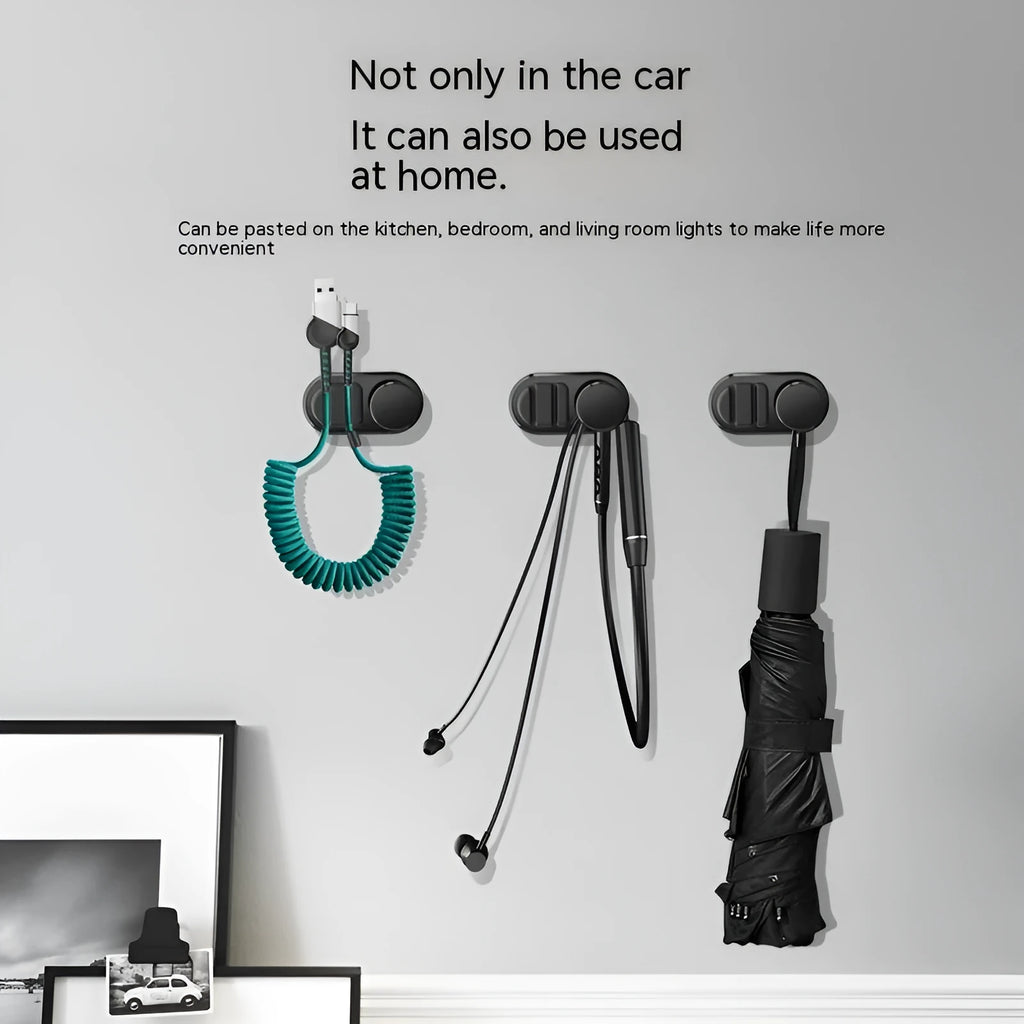 Adhesive car storage hook for cables in dark green colour showing dimensions and mounting surface