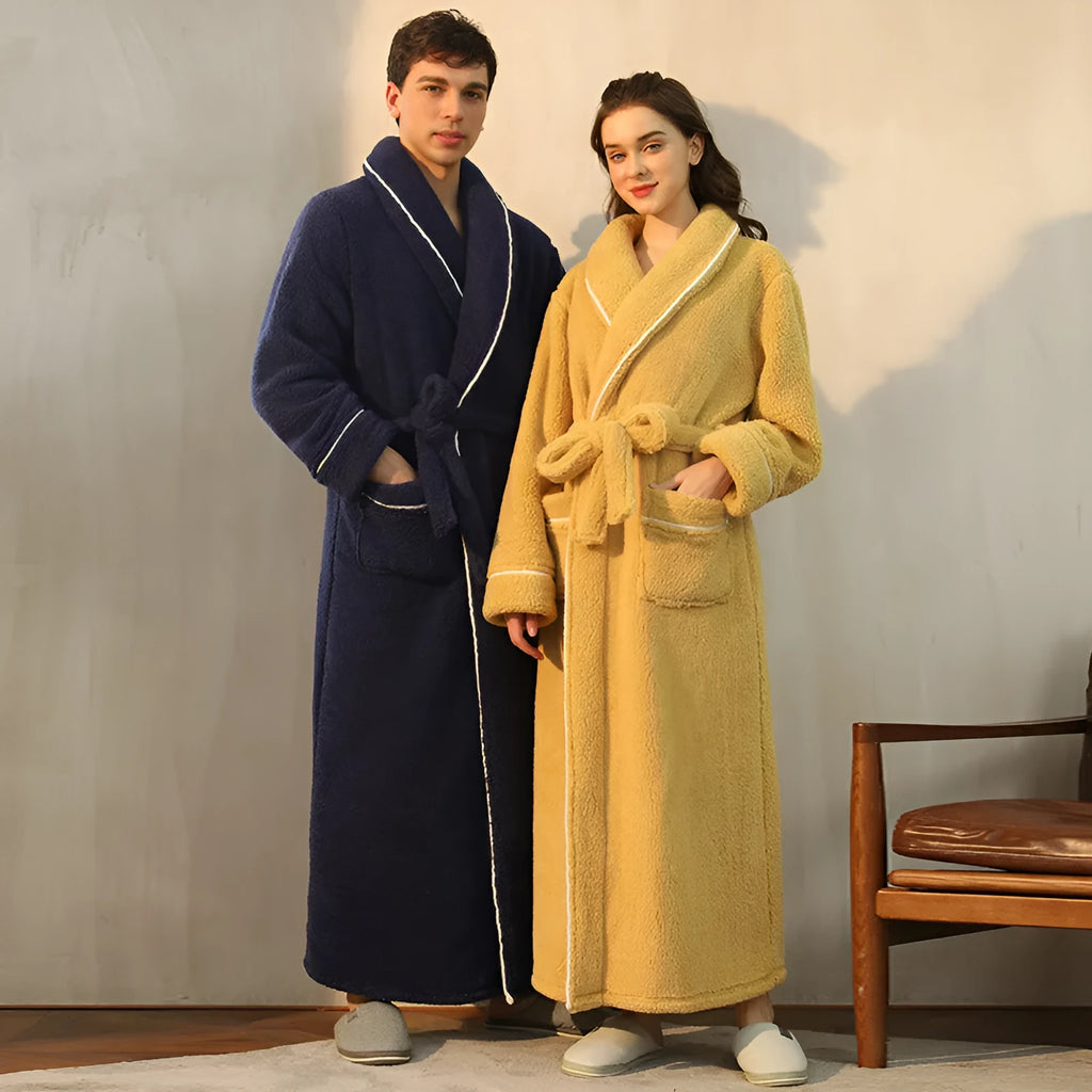 Man and woman wearing matching thick navy blue flannel bathrobes, showcasing the couple's winter loungewear.