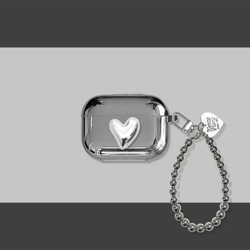 Electroplated solid colour iPhone headphone case with heart pendant attachment on a soft TPU shell.