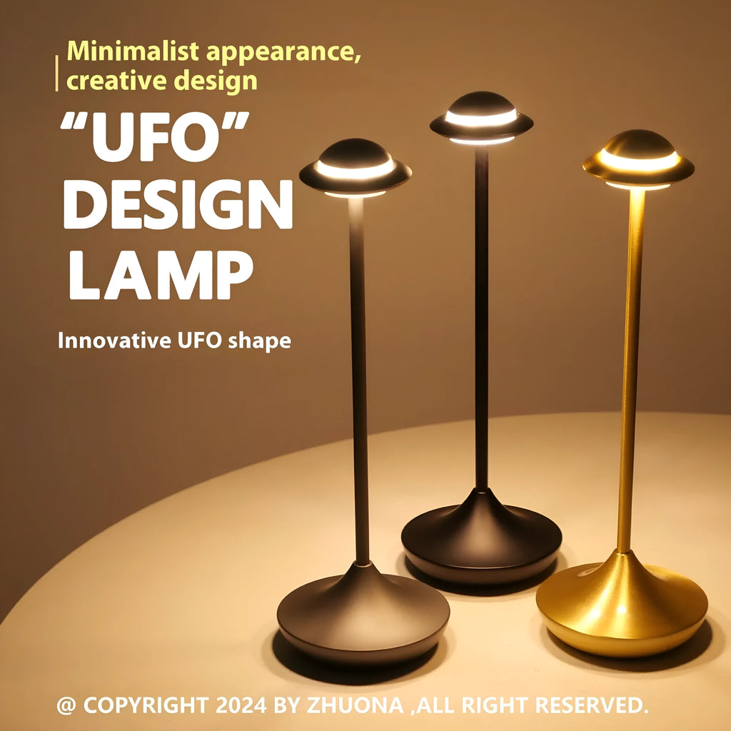 Modern UFO-shaped metal table lamp in black on a wooden desk, showcasing its rechargeable, touch-dimming design.