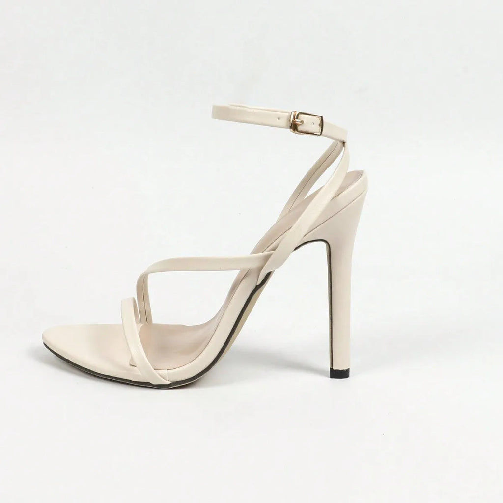 Women's metallic high-heel sandals with round open toe, multi-stripe pattern, and crossed ankle straps on a rubber sole.