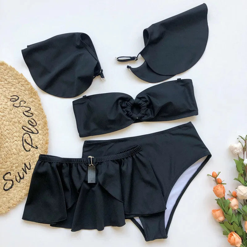 Women's black three-piece flounced bikini swimsuit with ruffled details on mannequin