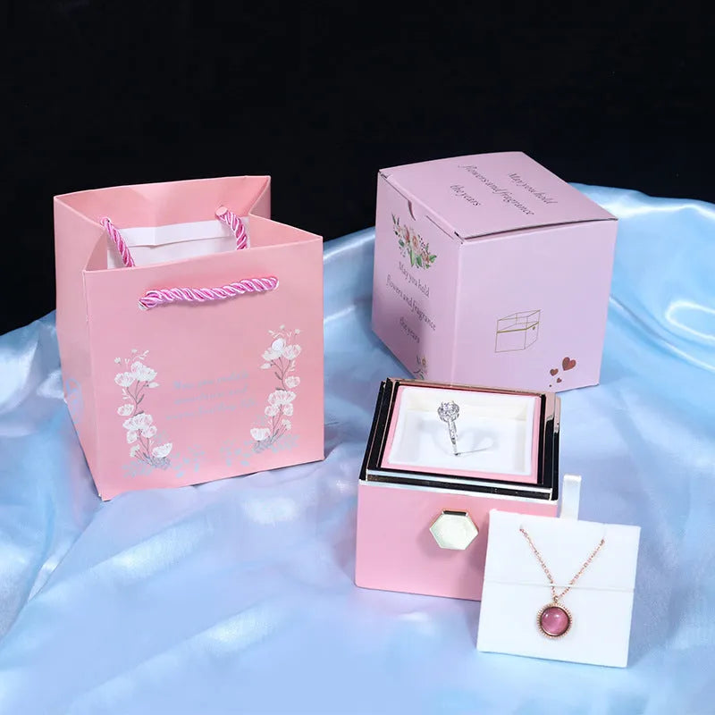 Rotating drawer jewellery gift box with preserved red rose under clear acrylic dome.